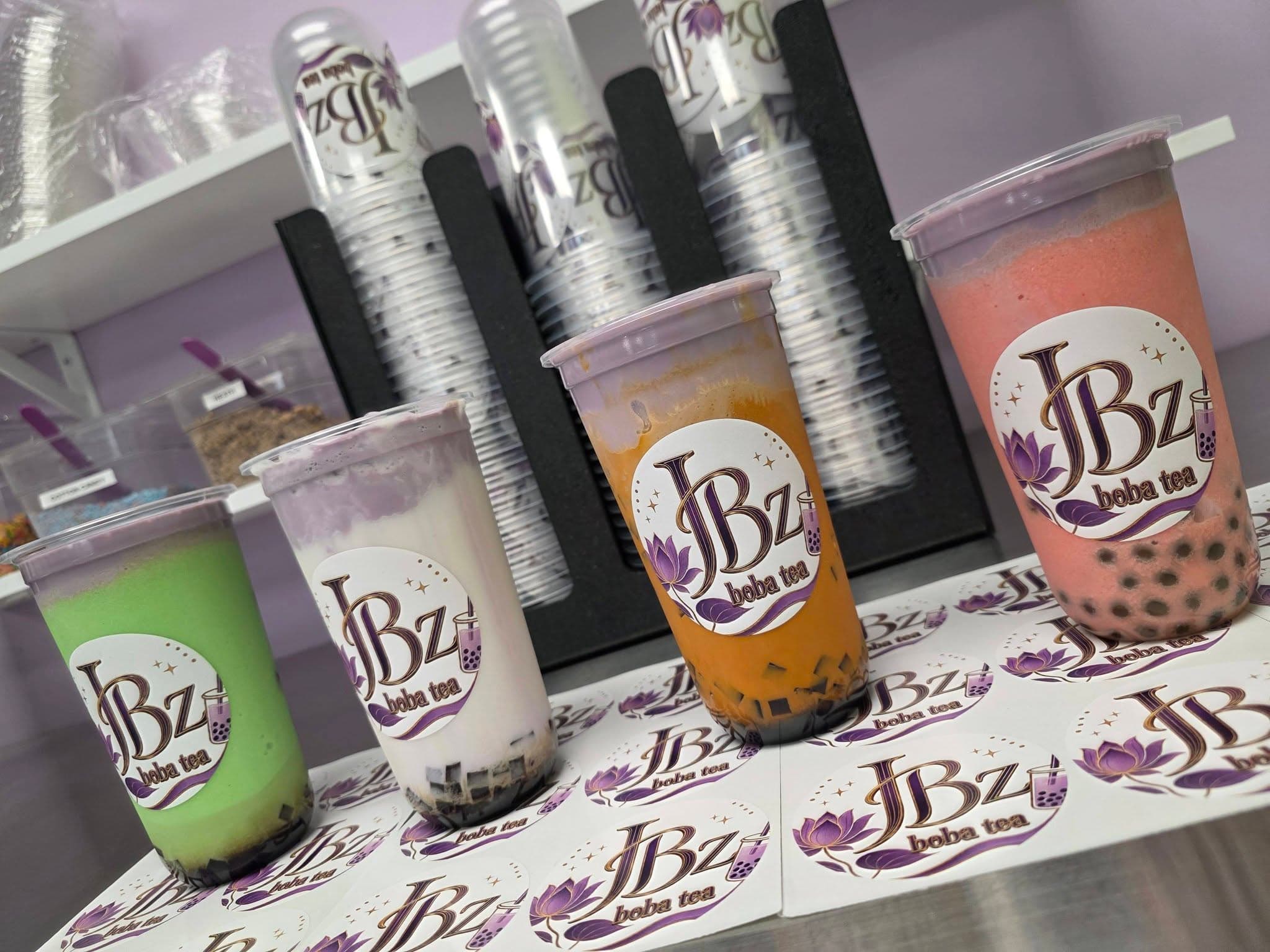 A colorful lineup of JBz boba drinks on the counter