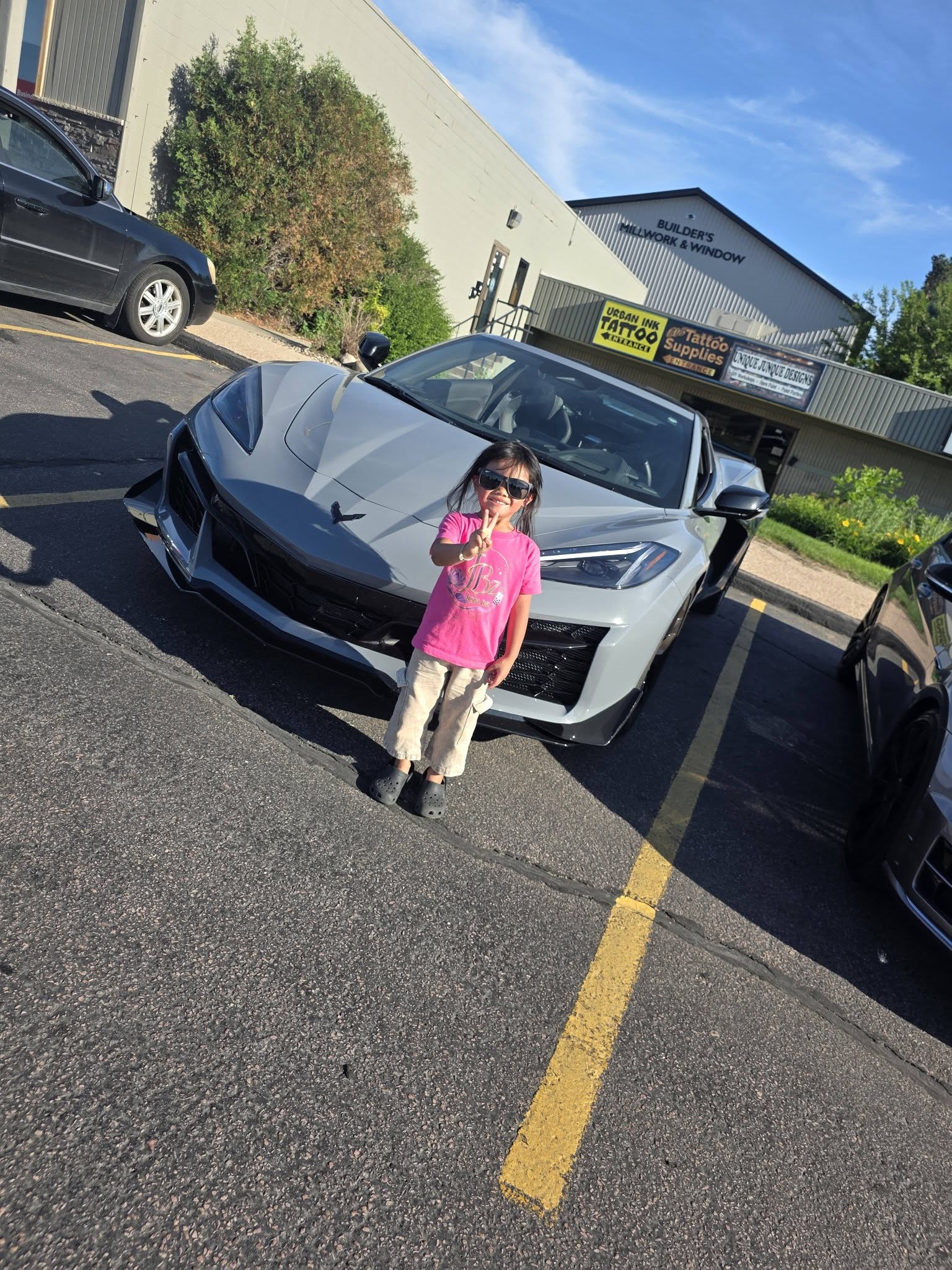 A kid checking out a Corvette at the family-friendly meet