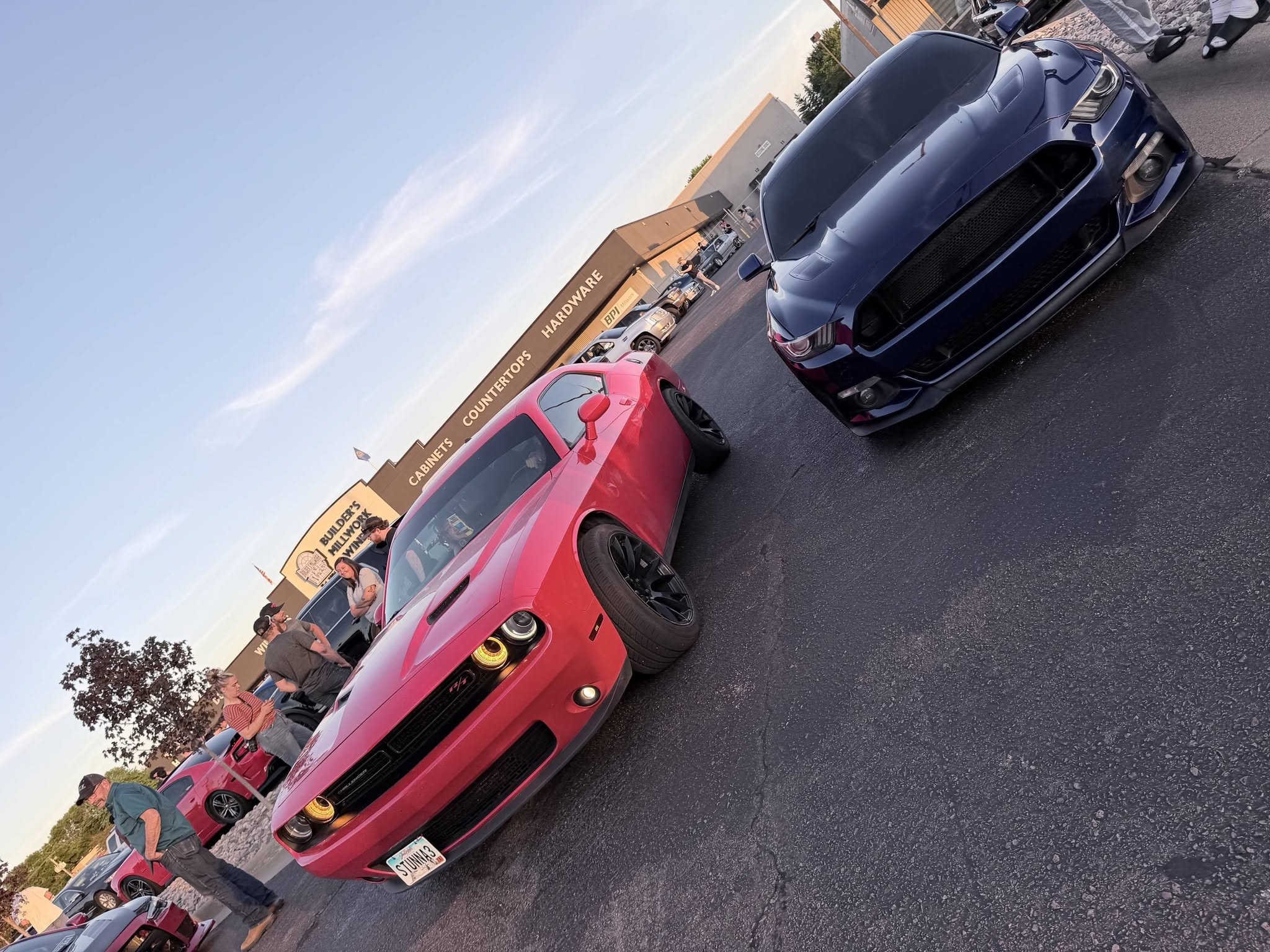 A row of muscle cars lined up at the JBz car meet