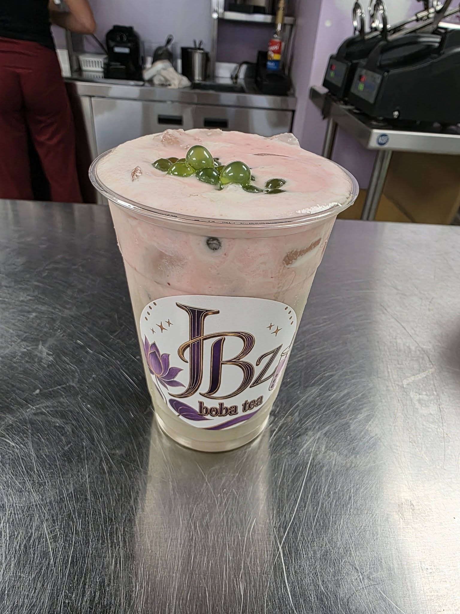 A JBz matcha drink from above, bright green with a cream cap