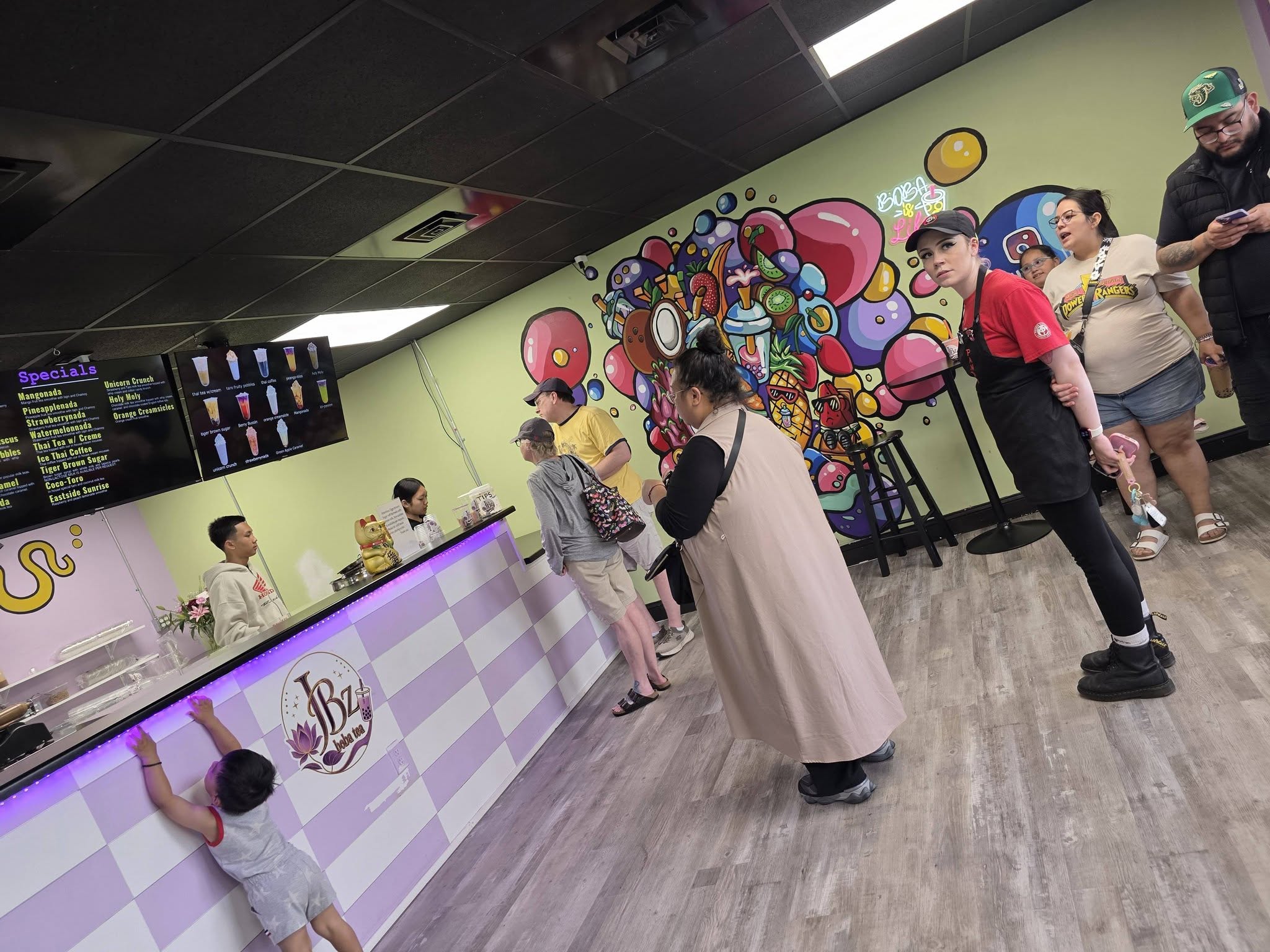 Inside JBz on a celebration day, balloons up over the counter