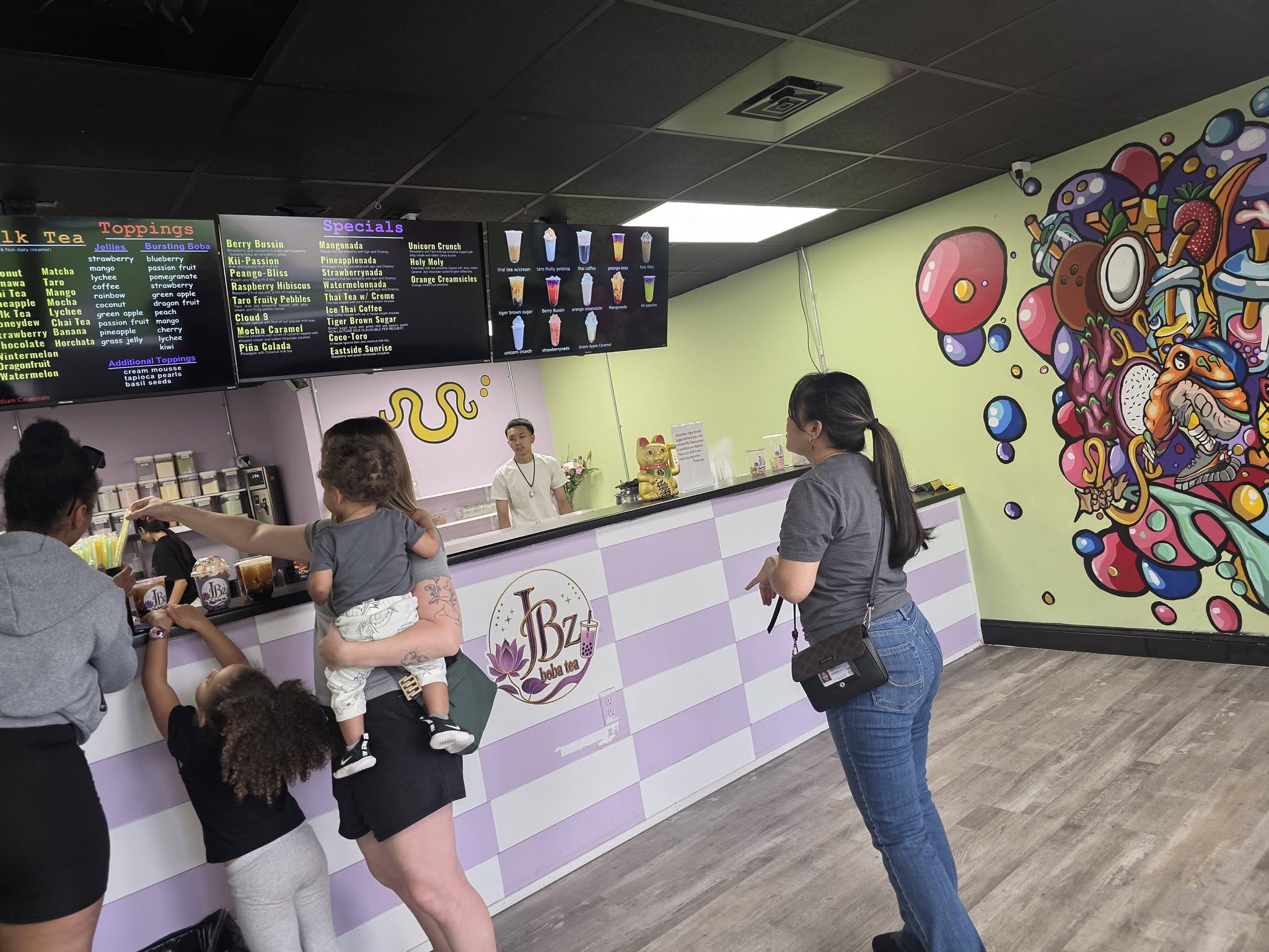 The JBz order counter under the shop's flower mural