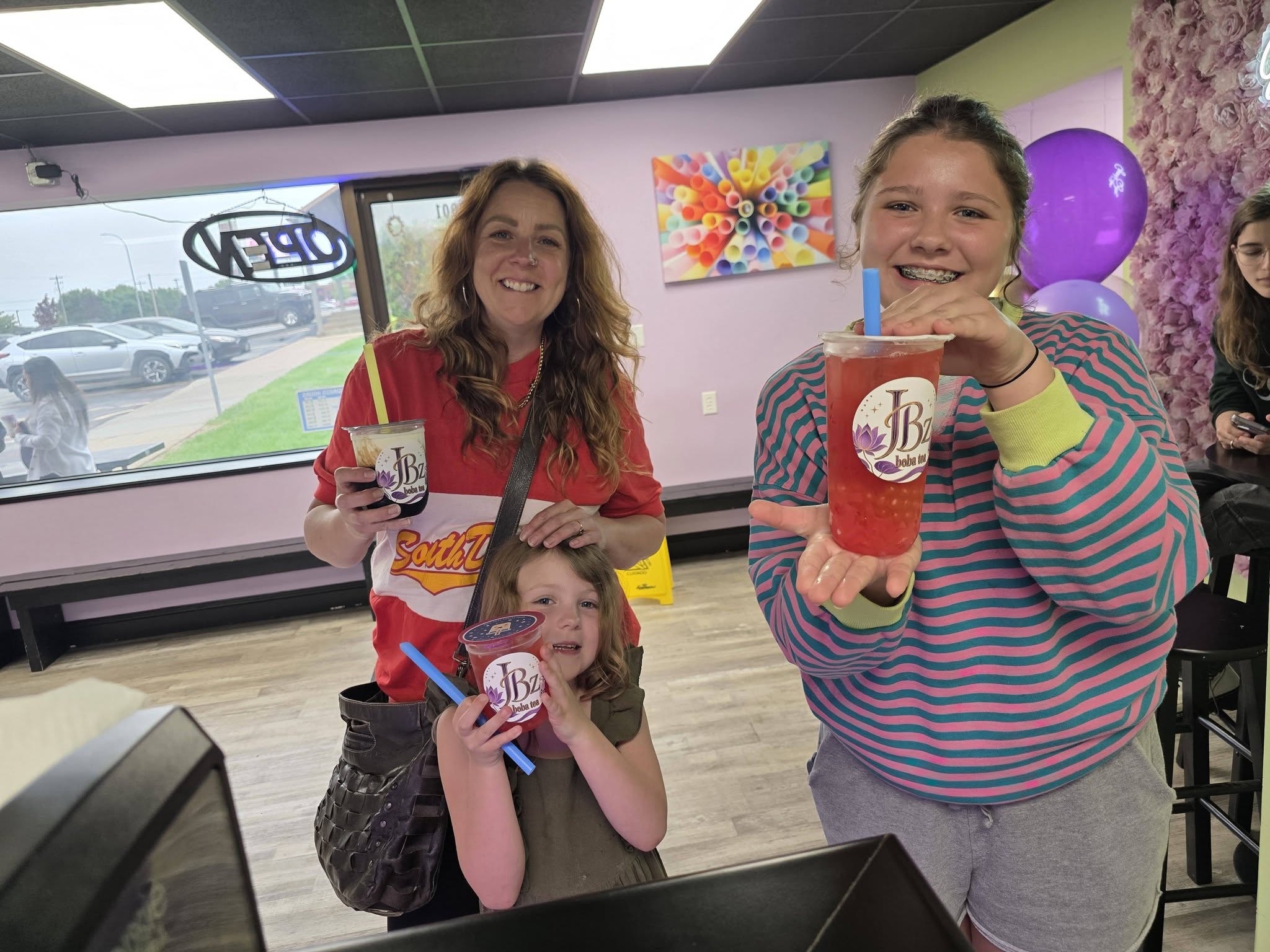 Two friends holding up their JBz drinks